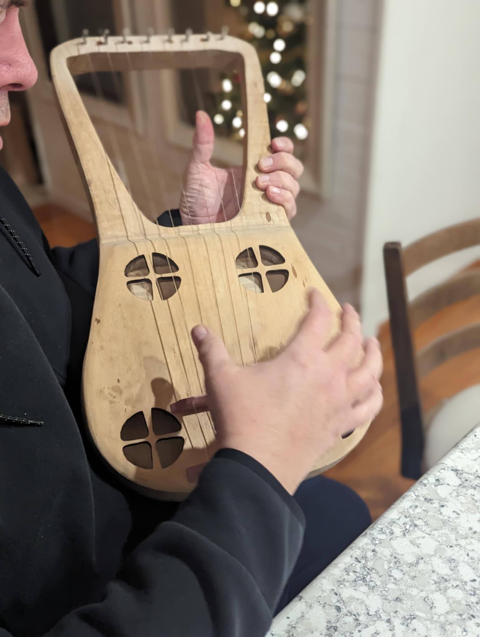 Other handmade string instrument being played